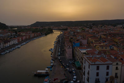 High angle view of townscape by river against sky