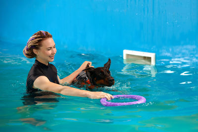 Portrait of young woman swimming in pool