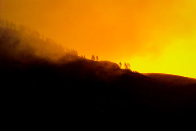 Scenic view of silhouette mountain against sky at sunset
