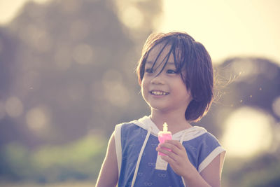 Portrait of smiling boy against sky