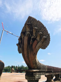 Low angle view of statue against cloudy sky