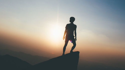 Silhouette of woman at sunset