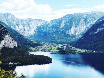 Scenic view of lake and mountains against sky