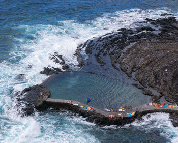 High angle view of people in a natural swimming pool in town