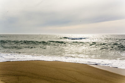 Scenic view of beach against sky during sunset