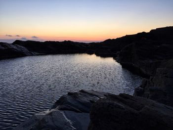 Scenic view of sea against sky at sunset