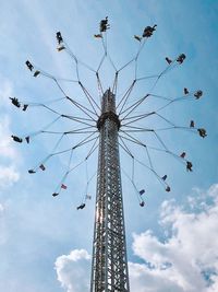 Low angle view of chain swing ride against sky