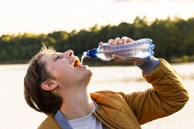 Young man drinking water bottle