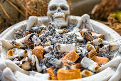 Close-up of ashtray with cigarette butts