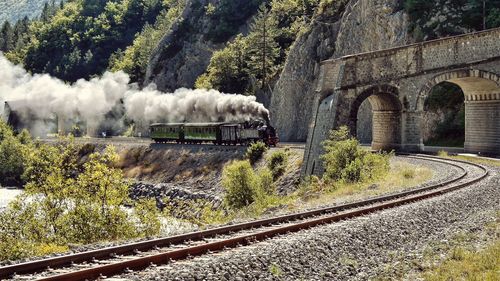 Smoke emitting from engine train on sunny day