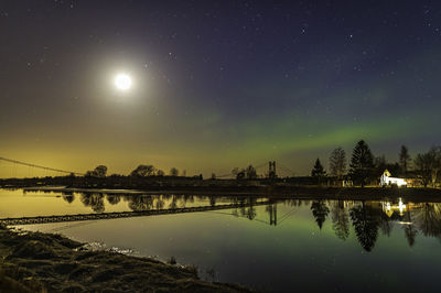 Scenic view of river against sky at night