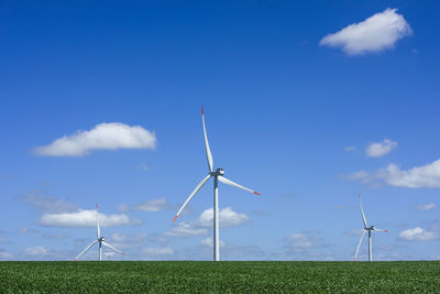 Windmill on field against sky