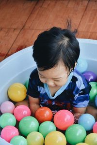 High angle view of girl playing with multi colored candies