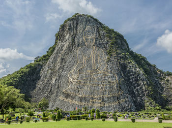 Group of people on rock against sky