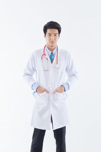 Young man standing against white background