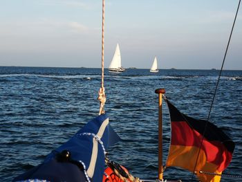 Sailboat sailing on sea against sky