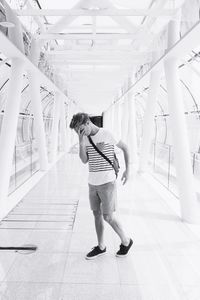 Full length of woman standing by railing