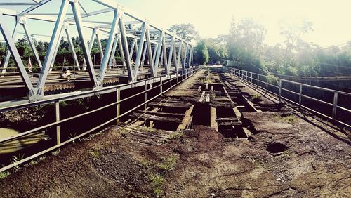 Surface level of railroad tracks against sky