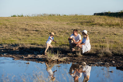 Rear view of people enjoying in water