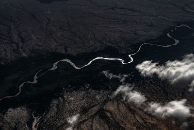 Aerial view of land and mountains against sky