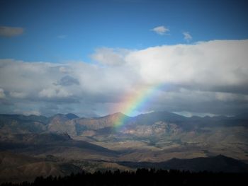 Rainbow over mountains against sky