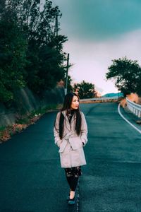 Woman standing on road