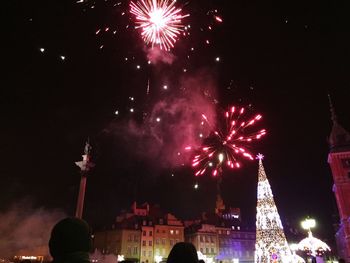 Low angle view of firework display at night