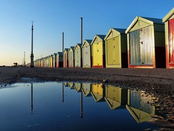 Reflection of beach huts on water