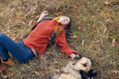 Woman with dog on field