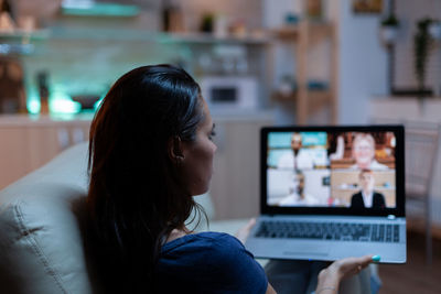 Young woman using laptop at home