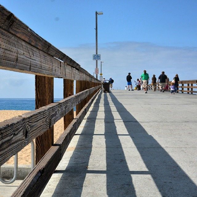 built structure, architecture, clear sky, water, connection, the way forward, bridge - man made structure, tourism, sea, railing, travel, travel destinations, sky, transportation, tourist, famous place, engineering, sunlight, diminishing perspective