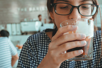 Close-up of woman drinking cold coffee