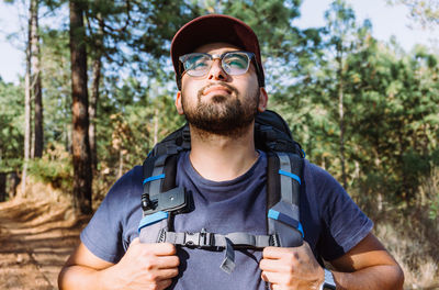 Portrait of young man holding camera