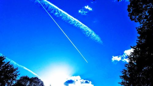 Low angle view of vapor trails in sky