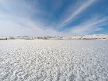 Scenic view of snow covered landscape against blue sky