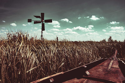 Cross on field against sky