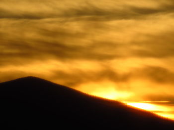 Low angle view of dramatic sky during sunset