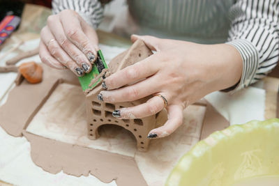 Women's hands knead clay, drawing elements of the product. production of ceramic products 