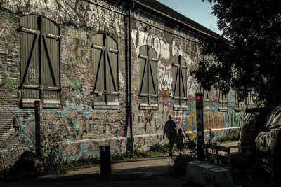 Abandoned building by street in city