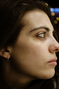 Close-up portrait of young woman looking away