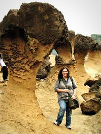 Full length of woman standing on rock