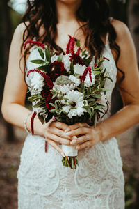 Midsection of woman holding flower bouquet