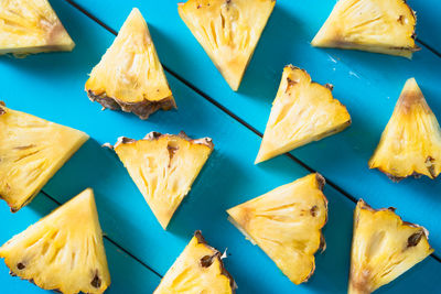 High angle view of lemon slice against blue background