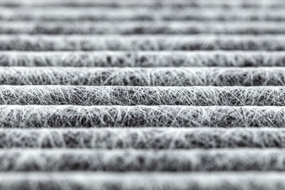 A macro shot of the surface rectangular, carbon cabin filter.fibers arranged in horizontal lines.