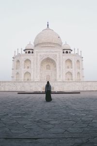 Rear view of woman standing at taj mahal