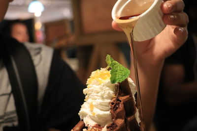 Close-up of hand holding ice cream cone