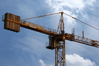 Low angle view of crane against sky