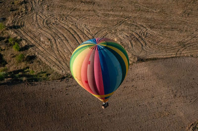 High angle view of hot air balloons on field