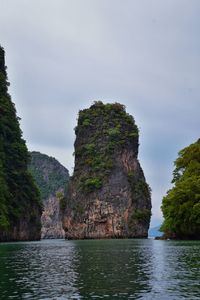 Rock formations by sea against sky