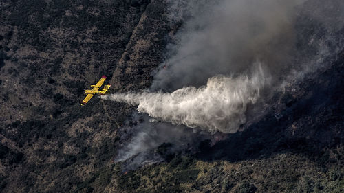 Aerial view of airplane crashing on land